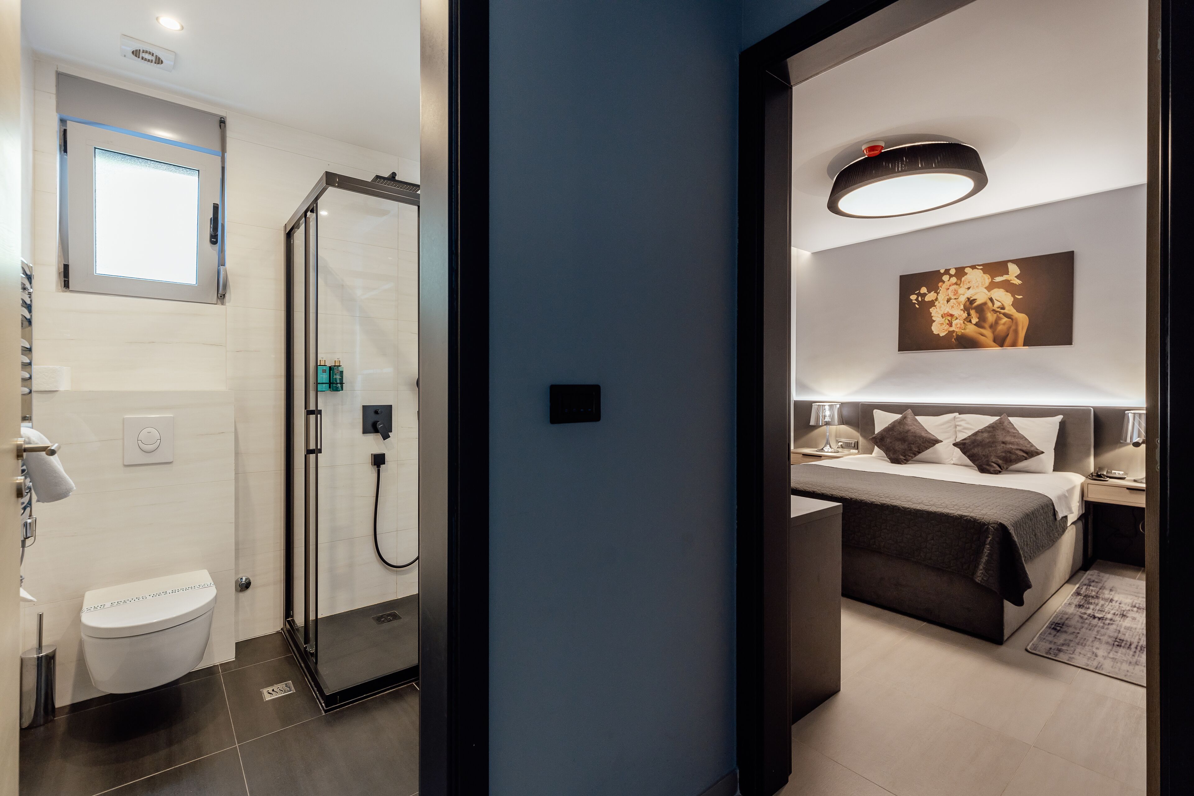 A modern bathroom with a toilet, shower, and a glass-enclosed shower area.