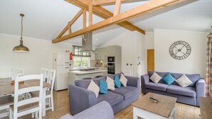 A modern living room with a dining area, kitchen, and a loft space. - 1 bedroom accommodation in Bewaldeth, Keswick (Bewaldeth, Keswick)