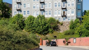 A multi-story hotel with a classic architectural style, featuring symmetrical windows and balconies.