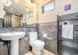 A modern bathroom with a sink, toilet, and towel rack. - Elkstone Premier Lodge (Ashbourne)