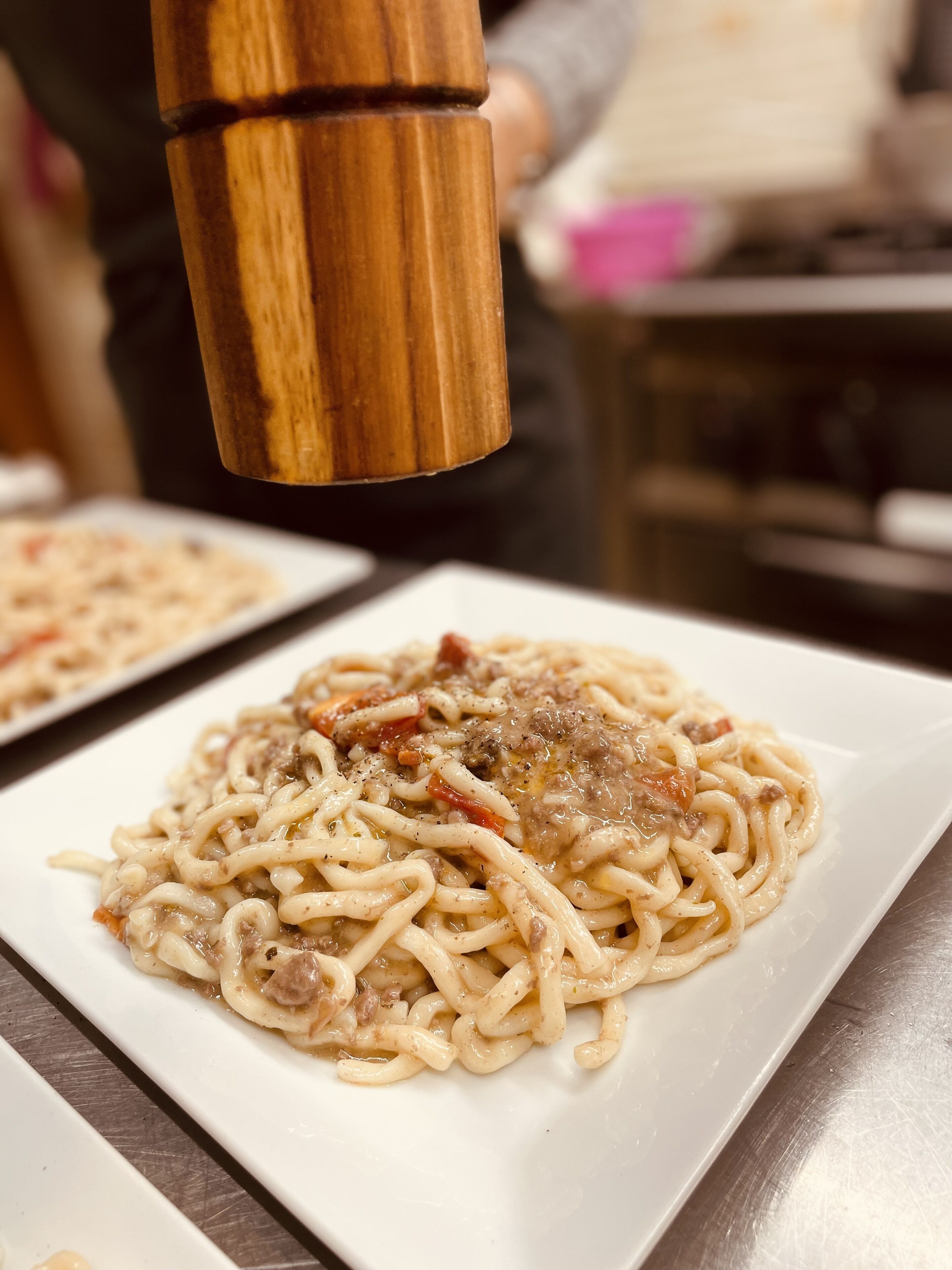 A close-up of a plate of spaghetti with meat sauce.