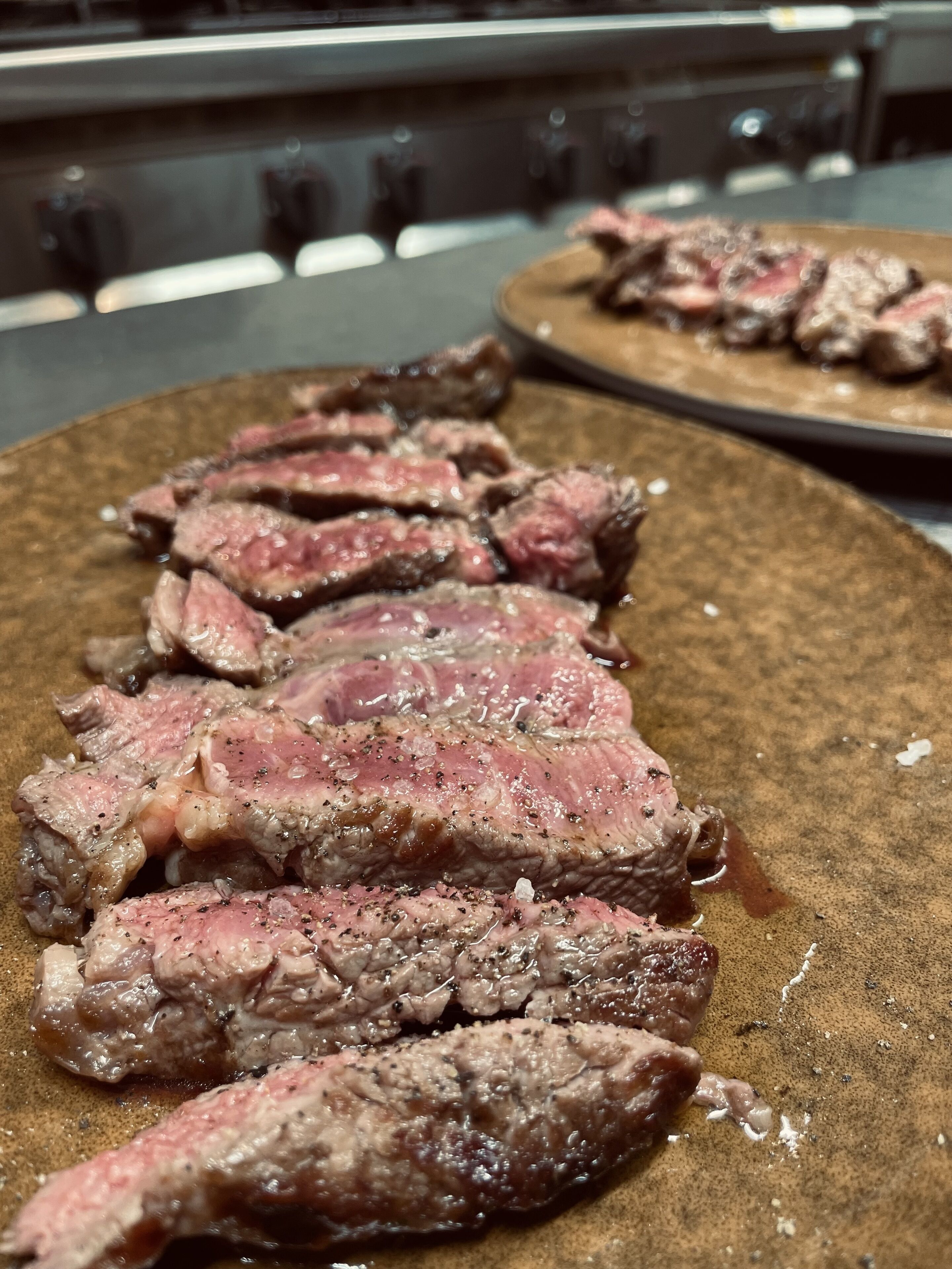 A close-up of sliced steak on a plate.