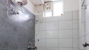A bathroom with a toilet, a shower, and a window. - IVA 1 BHK - w/ Wi-Fi, Kitchen, Food, Balcony, Garden (Sukha)