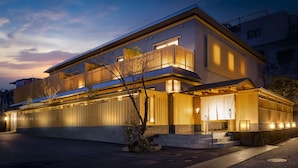 A modern two-story building with a flat roof, large windows, and a covered entrance area. - onomichi-hansei (Onomichi)
