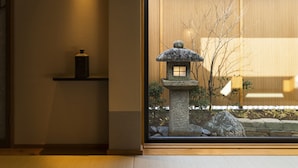 A traditional Japanese interior with a stone lantern, a wooden shelf, and a view through a window. - onomichi-hansei (Onomichi)