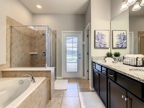 Bathtub, hair dryer, towels, toilet paper