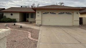 A residential house with a garage, a driveway, and a landscaped garden. - Sun Lakes Country Club (Sun Lakes)