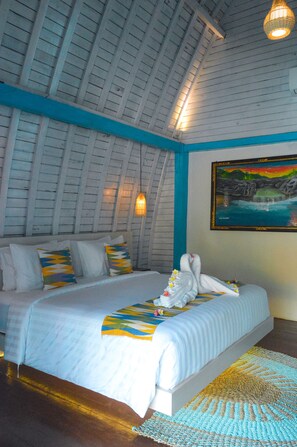 A bedroom with a bed, pillows, a painting, and a ceiling light. - The MG Villa & SPA (Penida Island)