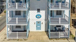 A two-story building with a blue door and a sign that reads "Arnold Arms." - Newly Remodeled Condo - Steps to Beach & Boardwalk (Ocean City)
