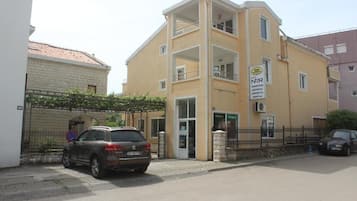 Two-story building with a glass entrance and restaurant on the ground floor.