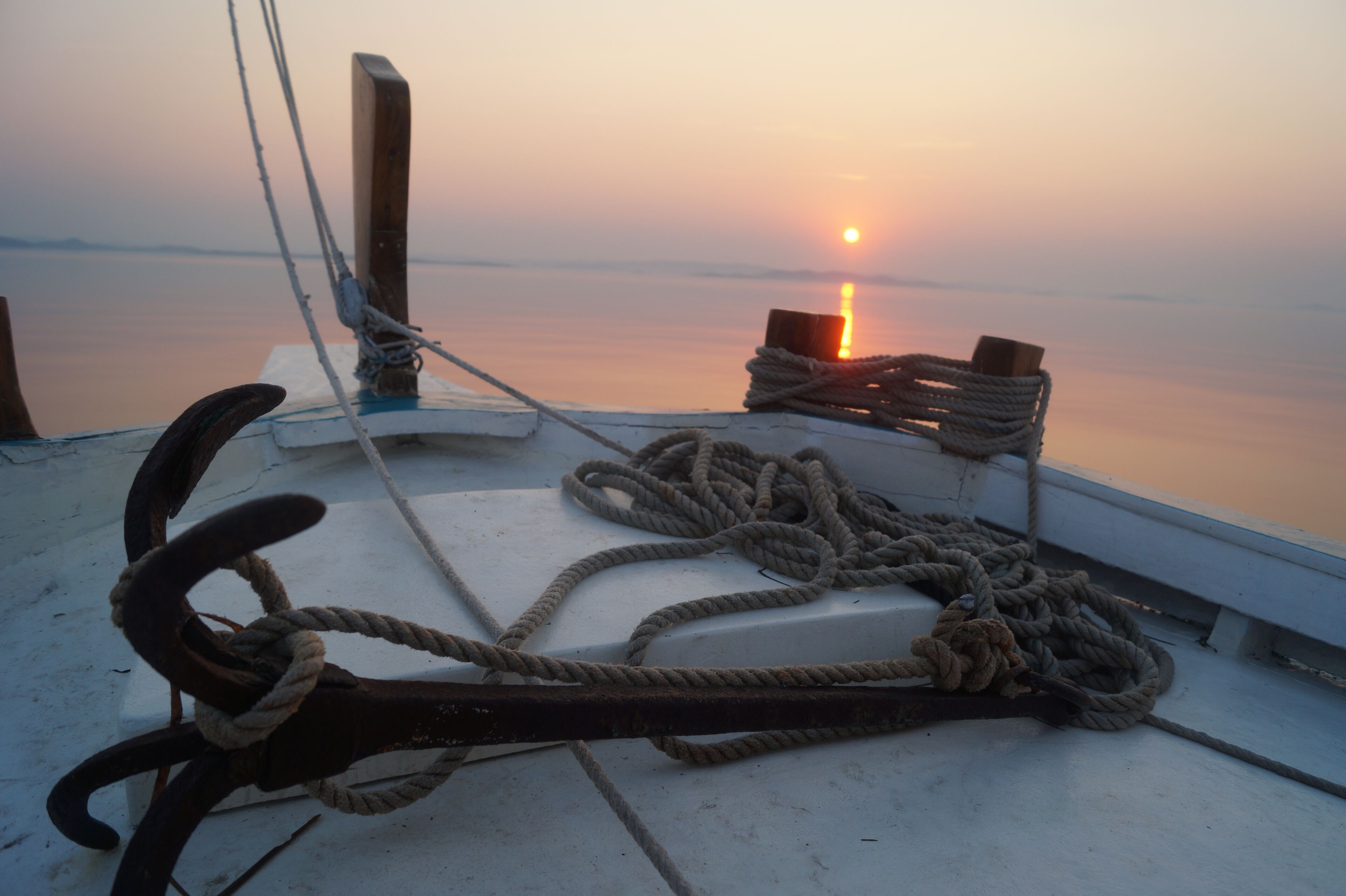 A boat deck with ropes and a wooden post.