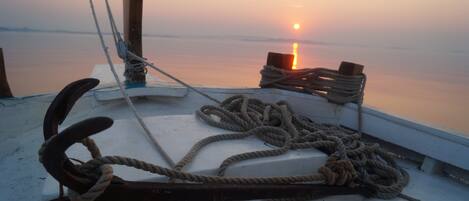 A boat deck with ropes and a wooden post.