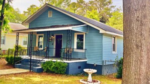 A single-story house with a front porch, a small garden with a birdbath, and a mailbox. - Home Near USC, Perfect for Families & Graduations - Deja Blues  (West Columbia)