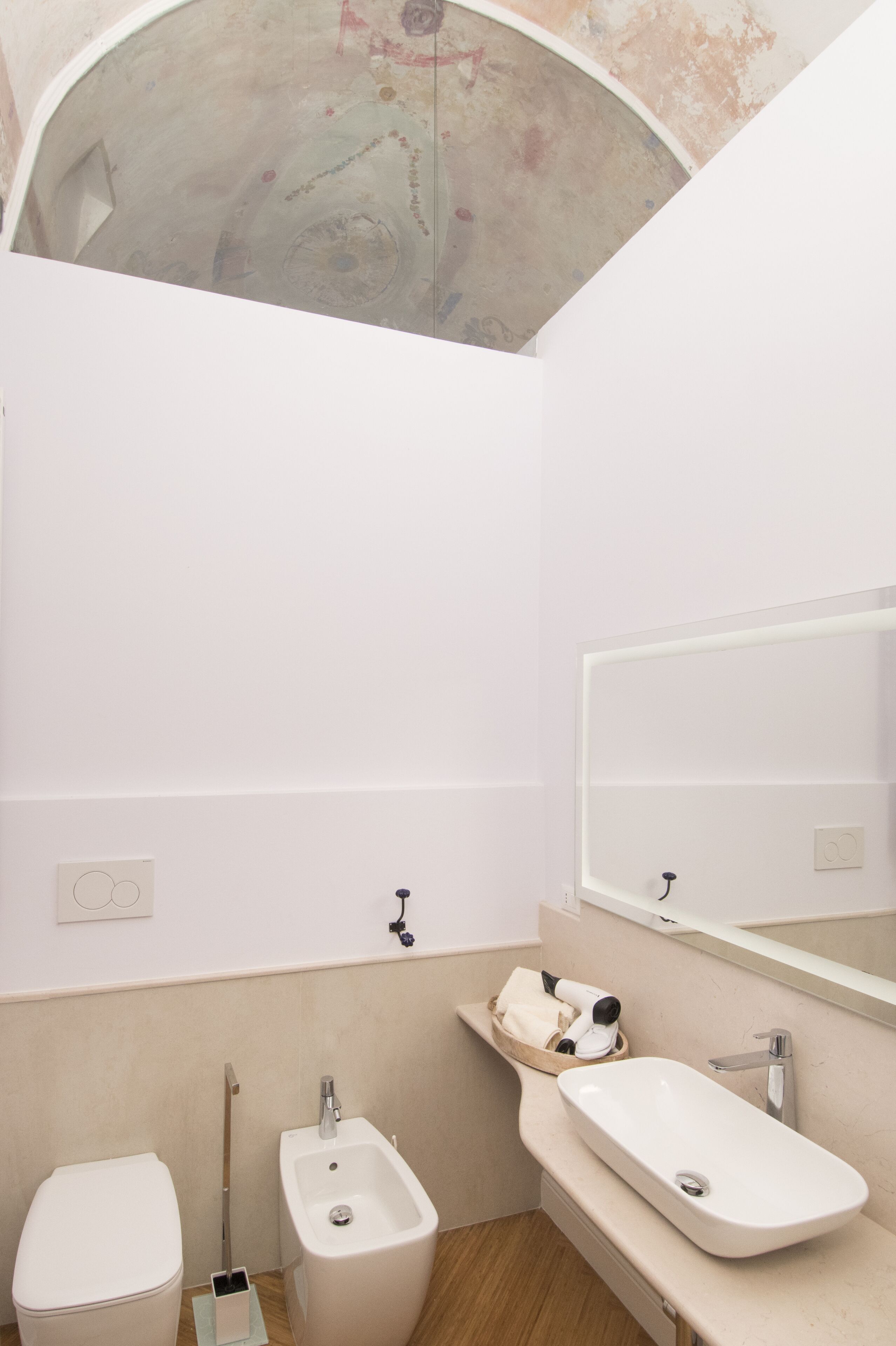 A small bathroom with a toilet, bidet, and sink.