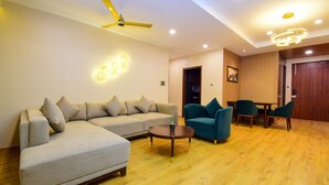 A modern living room with a sofa, chairs, a coffee table, and a ceiling fan. - Cliffton Valley by Dumnu Homes (Shimla)