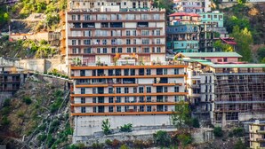A multi-story building with a series of balconies and a construction site in the foreground. - Cliffton Valley by Dumnu Homes (Shimla)