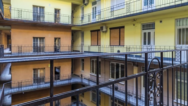 A multi-story residential building with balconies, a courtyard, and a metal railing. - Real Apartments Kertész II. (Budapest)
