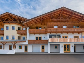 A multi-story hotel with wooden balconies and a sign reading "APARTMENTS Stuba". - Apartment Neustift Near Stubai Ski Lift (Neustift Im Stubaital)