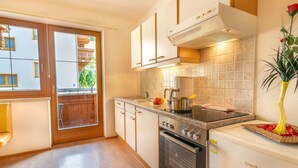 A modern kitchen with a built-in oven, a stovetop, and a coffee maker. - Apartment Neustift Near Stubai Ski Lift (Neustift Im Stubaital)
