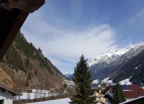 A mountain village with snow-covered peaks, houses with red roofs, and a clear sky. - Apartment Neustift Near Stubai Ski Lift (Neustift Im Stubaital)