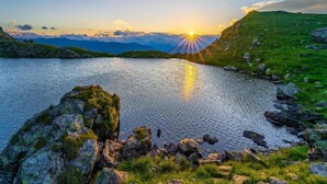 A serene lake with a clear sky and mountains in the background. - Apartment Neustift Near Stubai Ski Lift (Neustift Im Stubaital)