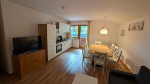 A compact living space with a kitchen, dining area, and a TV. - Apartment Neustift Near Stubai Ski Lift (Neustift Im Stubaital)