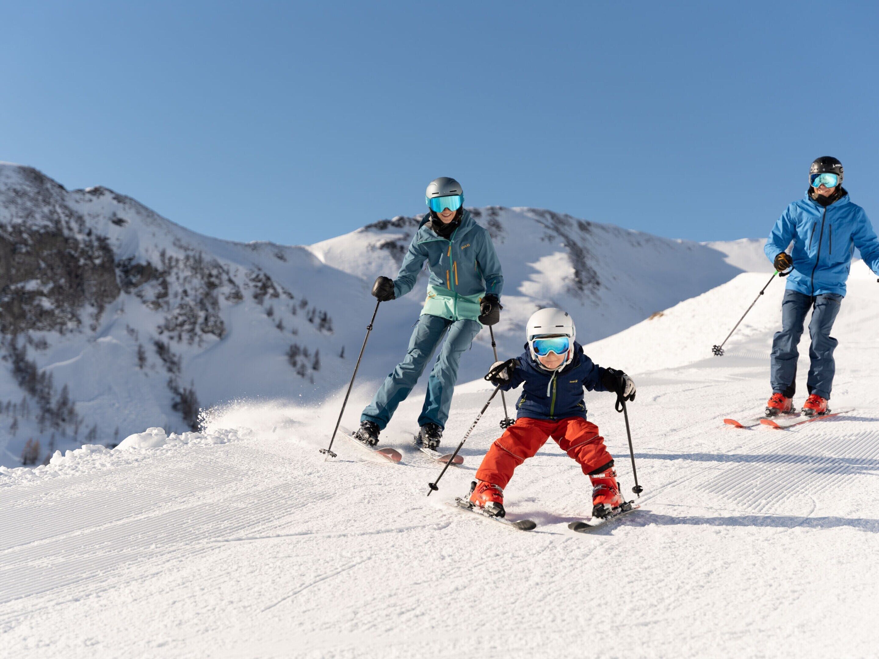 A snowy ski slope with skiers.