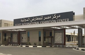 The entrance to the Egypt International Exhibition Center with a modern design, featuring a large signboard and a covered entrance area. - Local Style Khan El Khalili Decoration Living Room (Cairo)