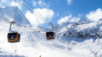 Eine Seilbahn in einer verschneiten Berglandschaft.