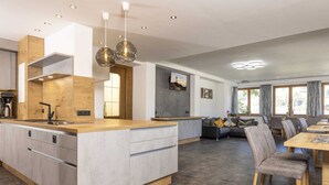 A modern kitchen with a central island, built-in appliances, and pendant lighting. - Moiklerhof Holiday Home in Ramsau im Zillertal (Ramsau im Zillertal)