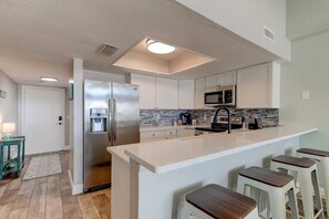 Fridge, coffee/tea maker, highchair, cookware/dishes/utensils