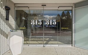 A modern building entrance with glass doors displaying the number 315 and the text "LOSO". - 315@Loso Hotel (Charlotte)