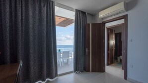 A room with a view of the sea, a wooden door, and a tiled floor. - Sea-View Apartment at WatersEdge Complex with two pools (Marsaskala)