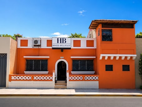 A two-story building with a sign reading 'HB HOTEL BELLA LUZ' and the number '1010' above the entrance.. Hotel Bella Luz Centro Historico