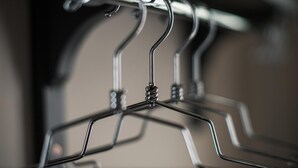 A close-up of a metal hanger with a twisted design, part of a clothing storage system. - Stagiates Guest House Room 2 (Volos)