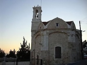 A church with a bell tower and a small window.