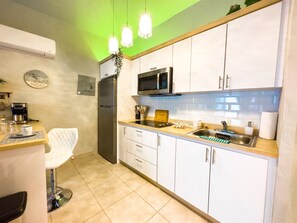 Fridge, microwave, stovetop, coffee/tea maker