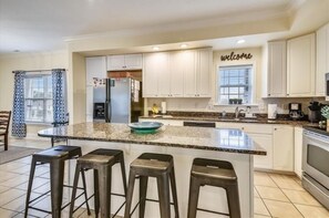Enjoy casual dining or socializing at the central island with bar stools.
