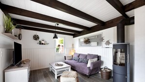 A cozy living room with a sofa, coffee table, and a fireplace.