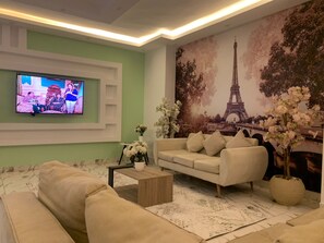 Grand Apartment | Living area | 55-inch Smart TV with satellite channels, TV - Casa Rosa - المهندسين (Giza)
