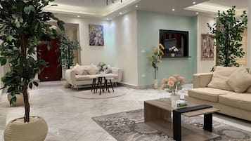 Grand Apartment | Living area | 55-inch Smart TV with satellite channels, TV