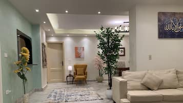 Grand Apartment | Living area | 55-inch Smart TV with satellite channels, TV