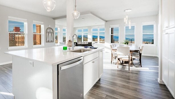 A modern kitchen with a large island, white cabinetry, and a view of the city. - King bed, water and city view, gourmet kitchen, Jewel of Fairhaven  FT505 (Bellingham)