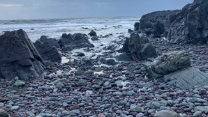 A rocky beach with large boulders and waves crashing against the shore. - Ballycotton Holiday Apartment No 6 (Ballycotton)