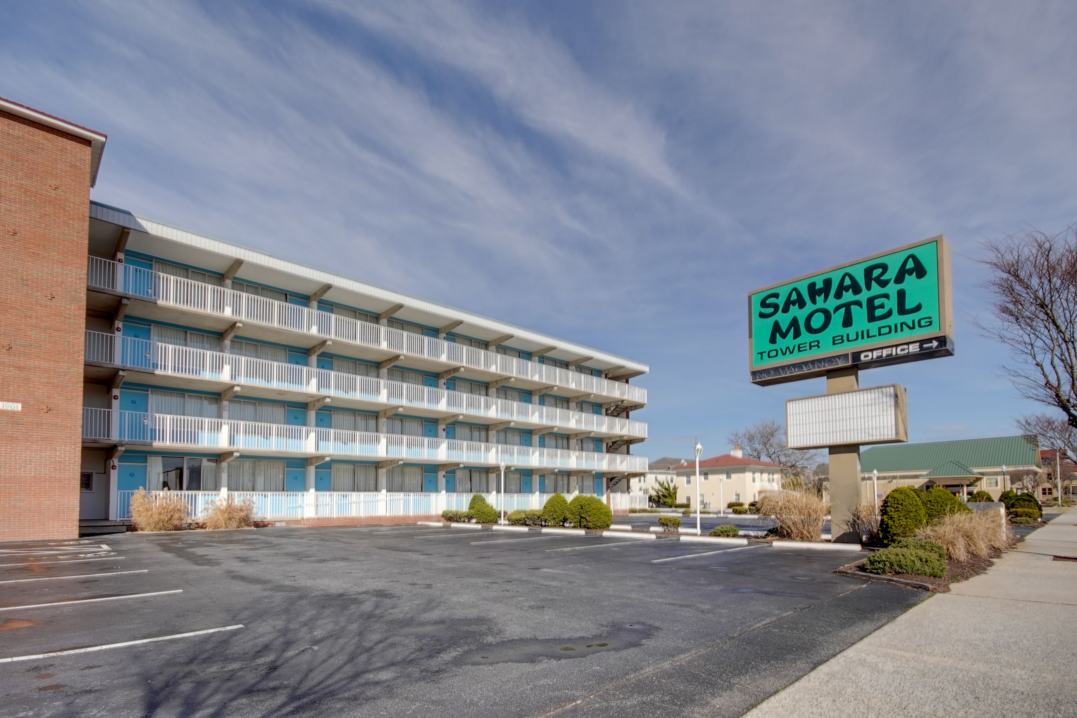 A multi-story motel with a sign reading "Sahara Motel Tower Building."