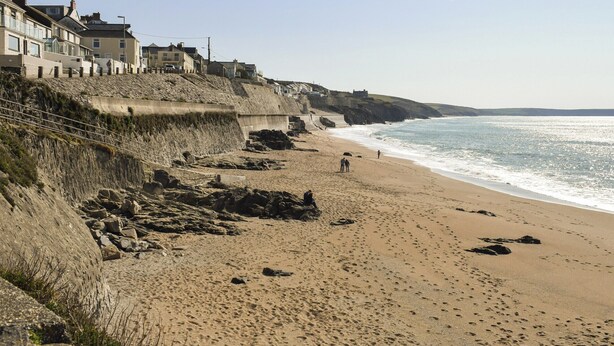 A sandy beach with a rocky cliff and houses on the left. - 3 bedroom accommodation in Porthleven (Porthleven)