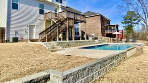 A two-story house with a wooden staircase leading to a deck, a swimming pool, and a fenced backyard. - 2026 Master’s Rental, 3 Story with pool—Just 12 Miles from the Augusta National (Evans)