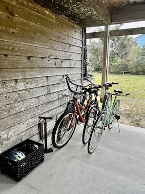 Relax on the covered porch, surrounded by lush greenery and a tranquil yard.