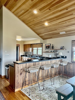 Enjoy cooking in this well-equipped kitchen with a central island and bar stools.