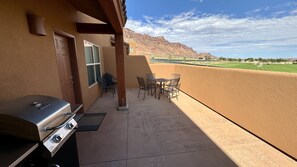 Enjoy al fresco dining on the patio, where a barbecue grill and table with chairs await.
